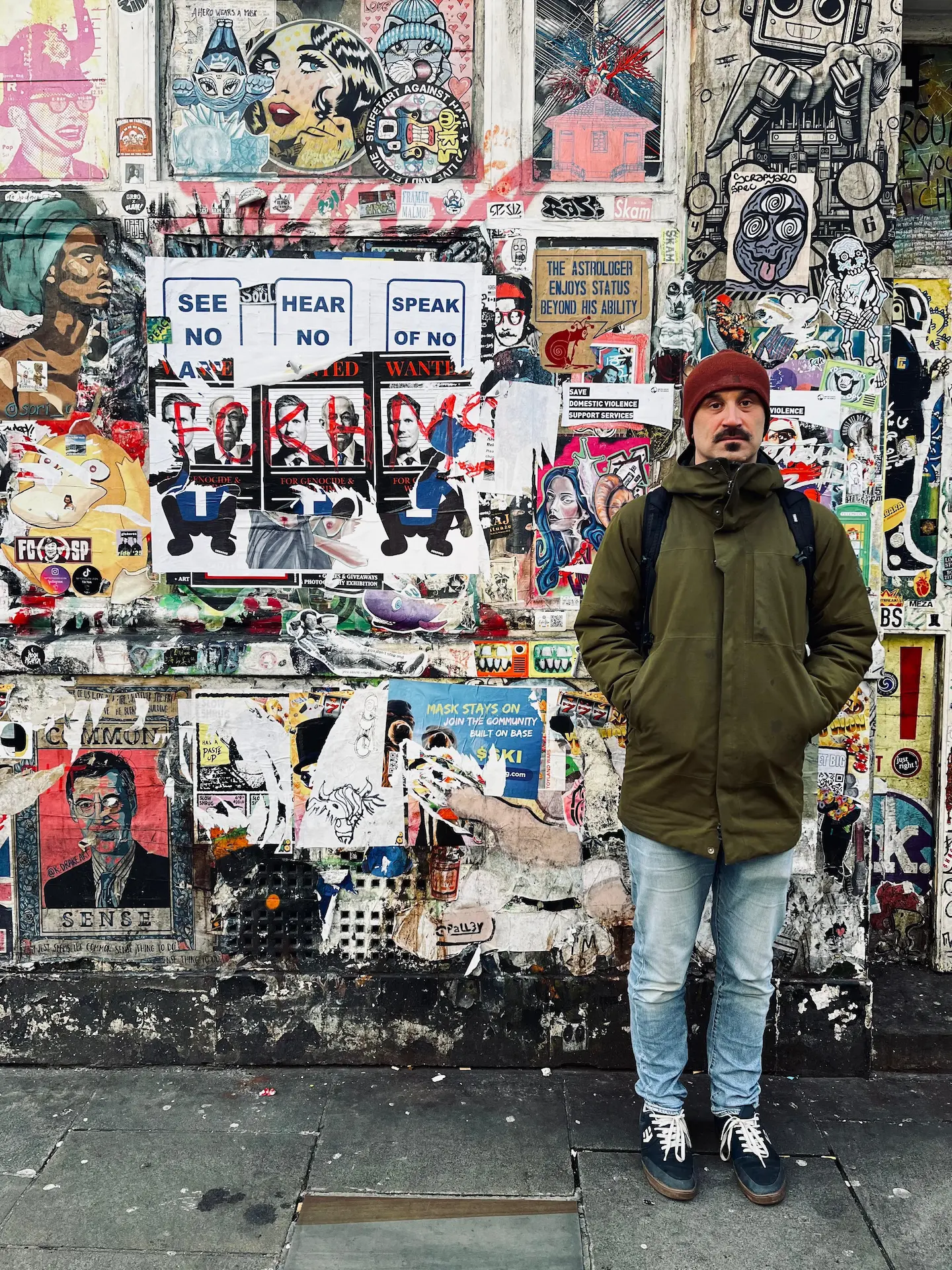 Will Falkowski in front of a colourful street art wall